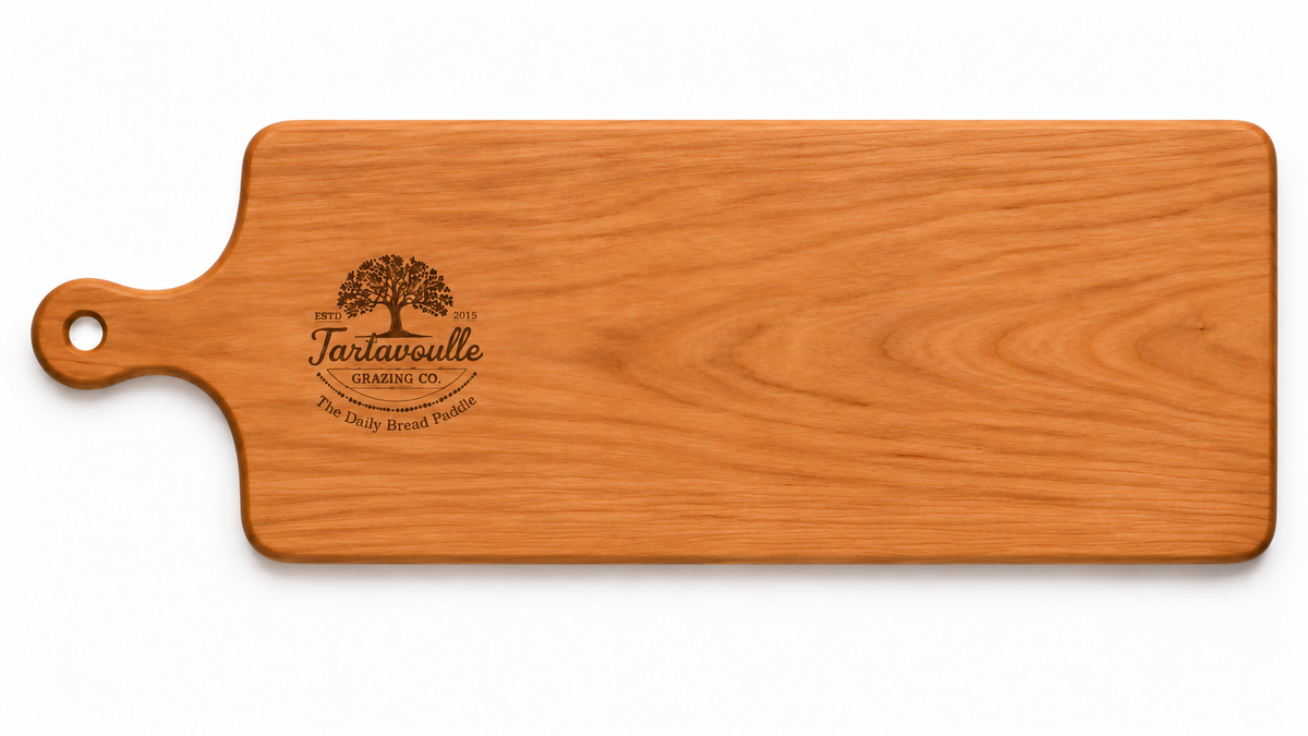 Daily Bread Paddle in Cherry wood on a white background, 9 inch wide by 22.5 inch board body with a 4 inch handle